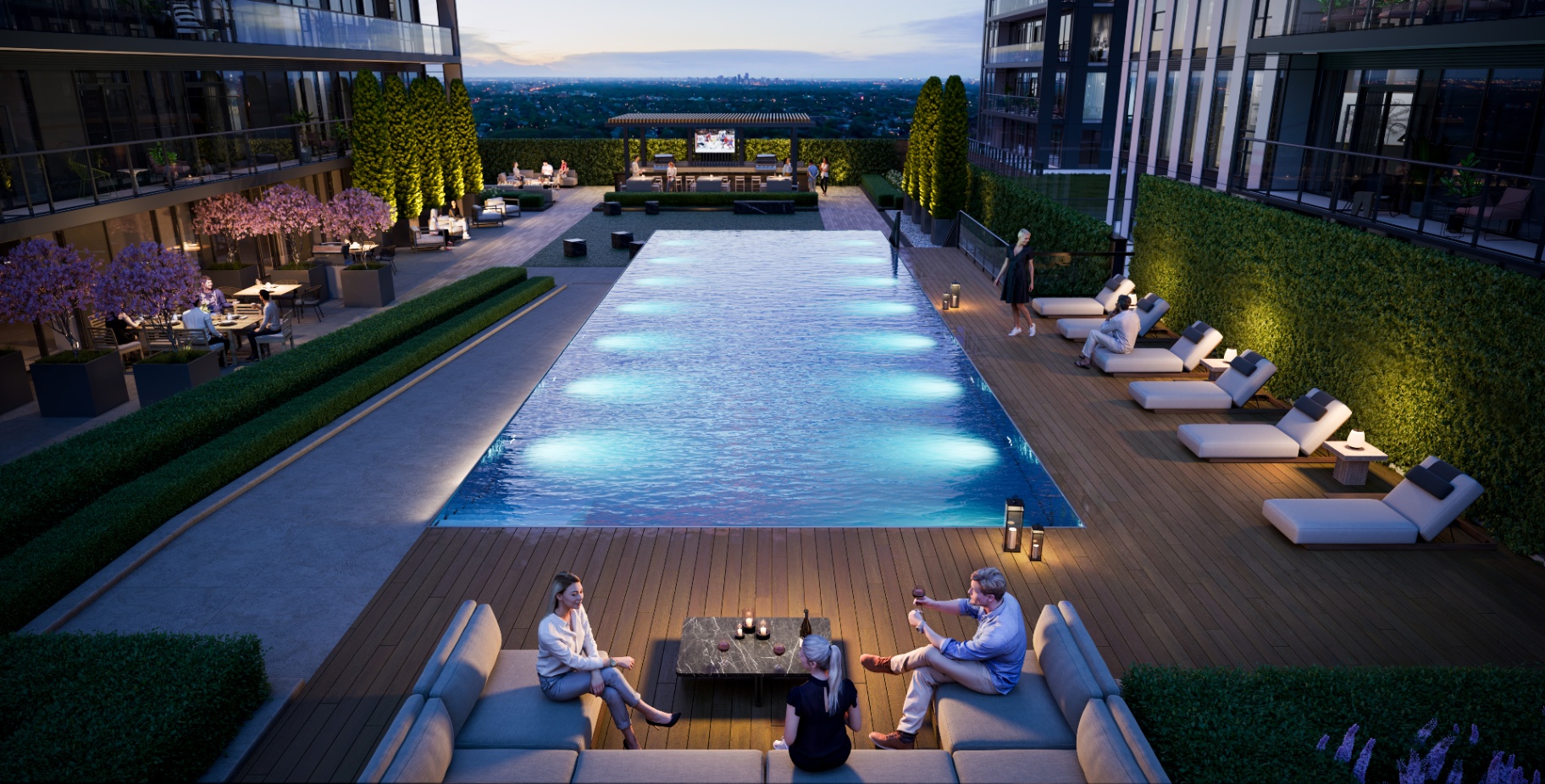 Outdoor pool at dusk with cabanas overlooking Hamilton skyline